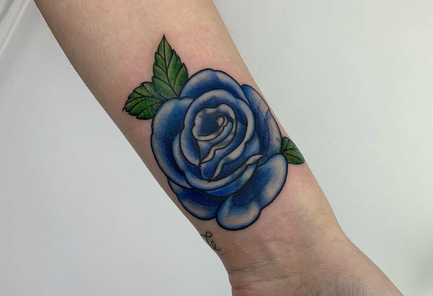 Watercolor style flower cover up tattoo on the right