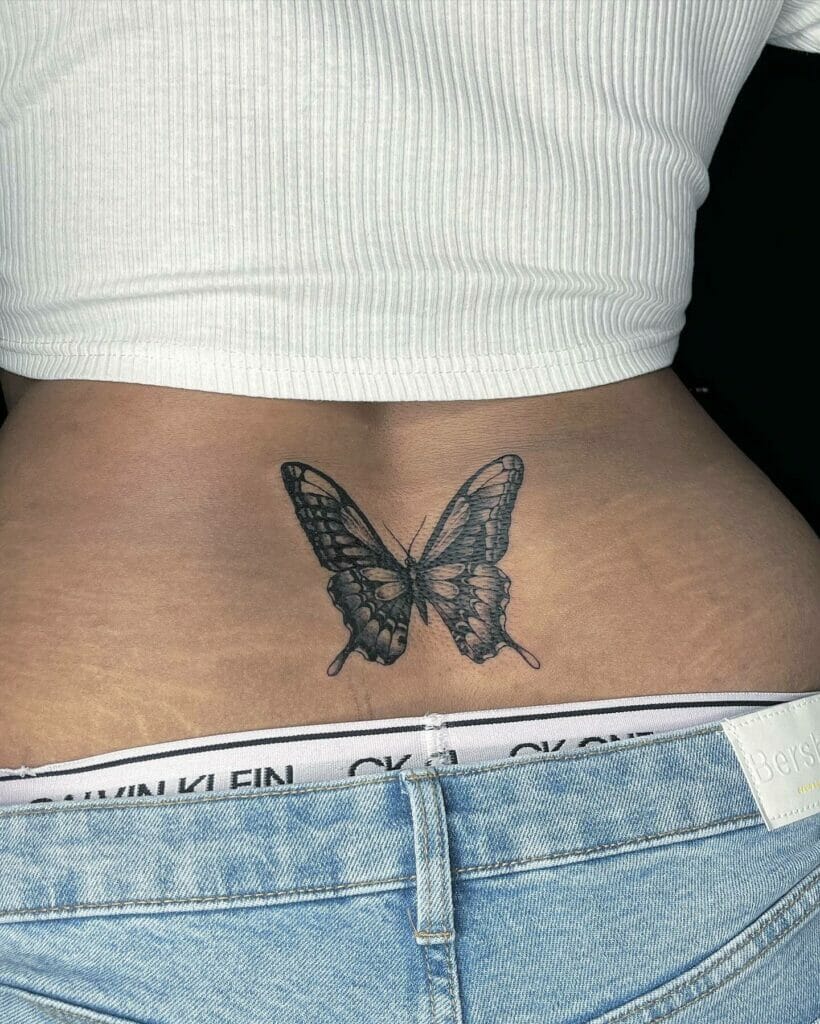 Black Ink Lower Back Butterfly Tattoo