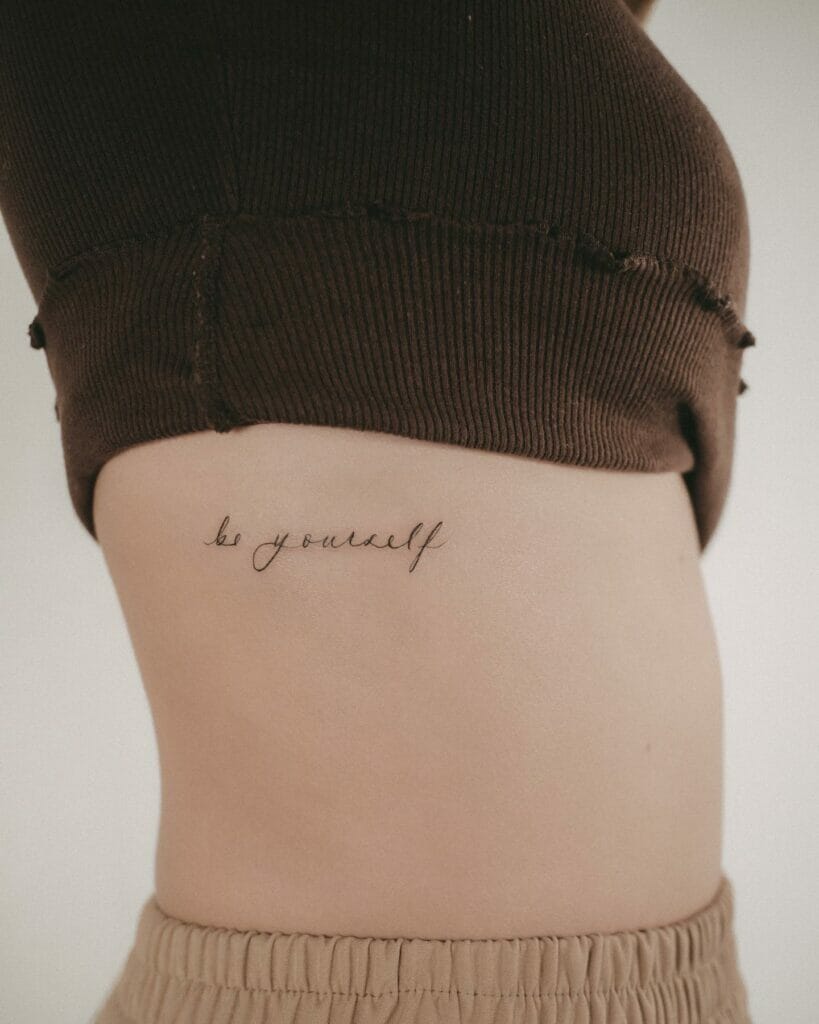 'Be Yourself' Lettering Tattoo On Rib Side