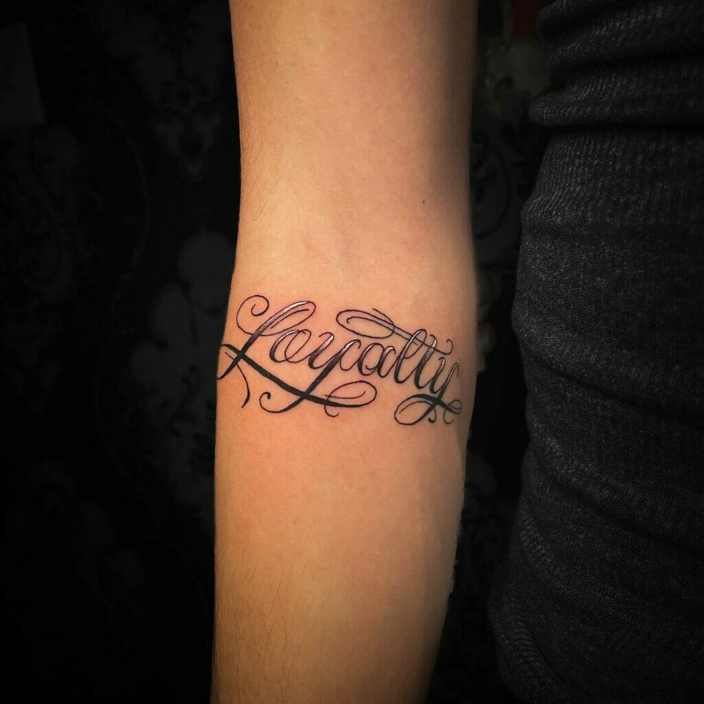 Cursive Lettering Loyalty Tattoo On Arm