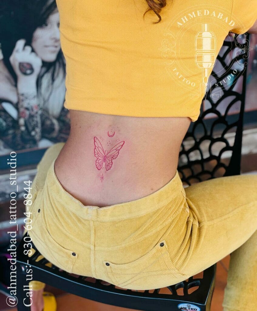 Red Ink Lower Back Butterfly Tattoo