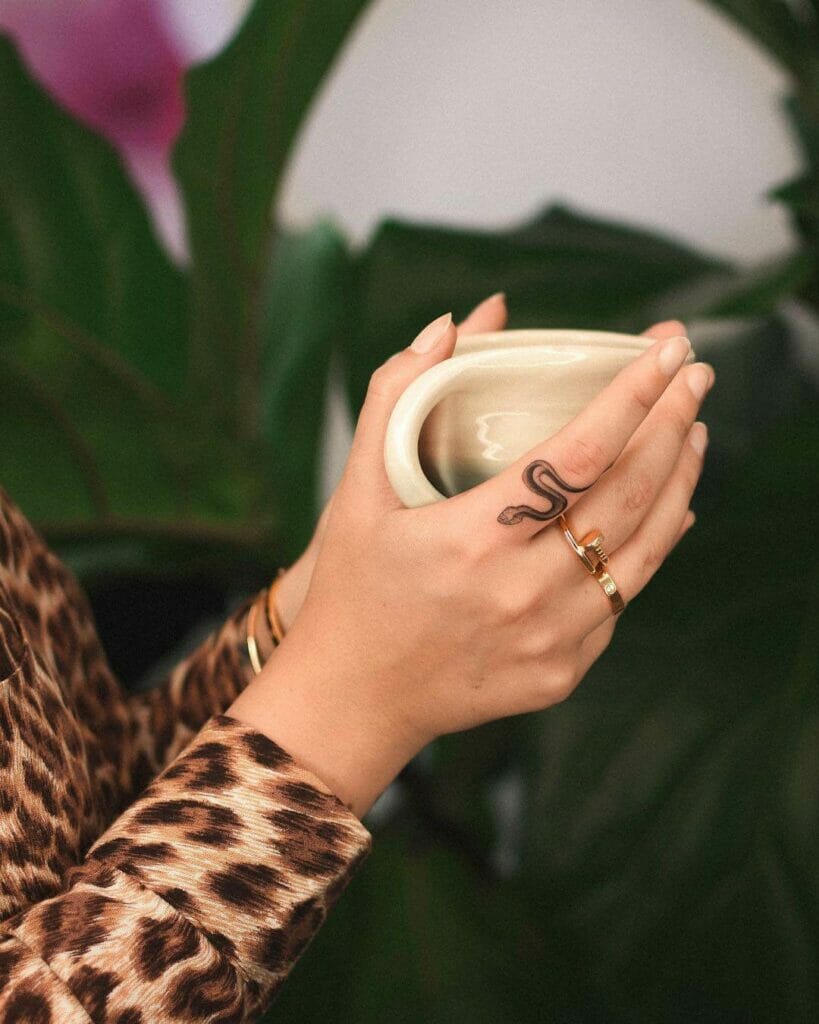 Stunning Tiny Black Sleek Snake Tattoo