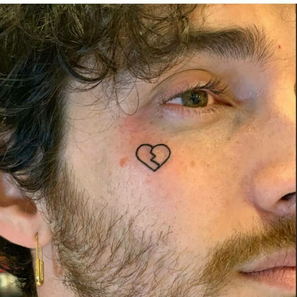 Small Broken Black Heart Face Tattoo
