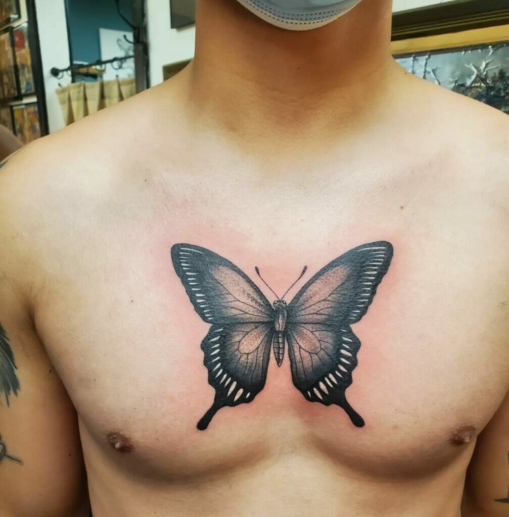 Bold Black-Inked Sternum Tattoo Butterfly
