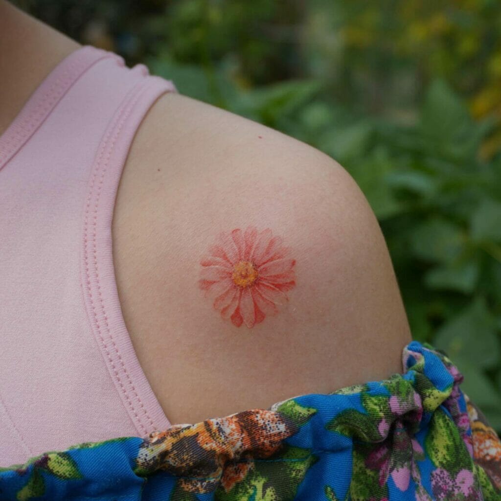Pink Daisy Tattoo On The Upper Arm
