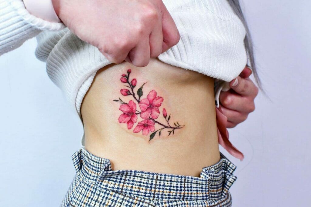 Pink Flower Tattoo Below The Chest
