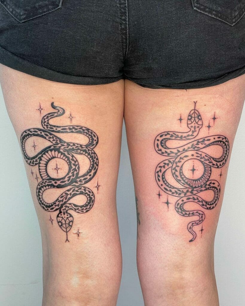 Matching Black and White Snake Tattoos on Thighs