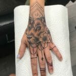 Lion On Hand Tattoo