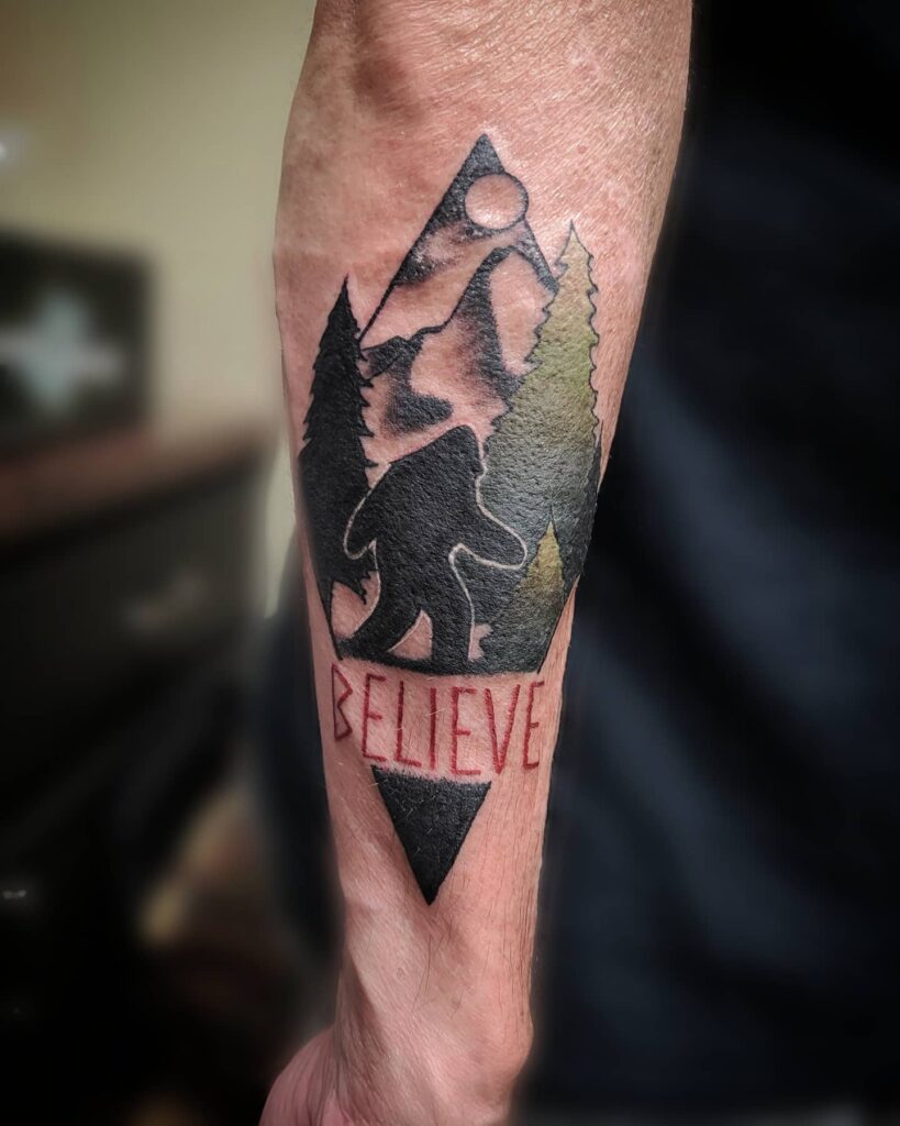 Bigfoot tattoo with the words "believe" or "never give up"