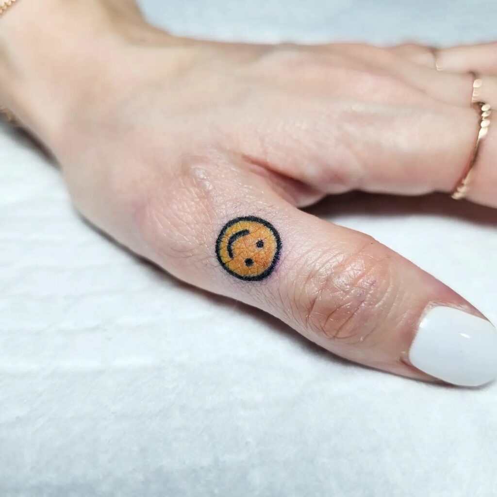 Cute Emoji Tattoo On The Finger Tip
