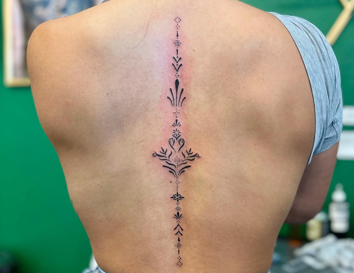 Tattoo uploaded by KTREW Tattoo • Hand-Poked Floral Spine Tattoo by  Pokeyhontas at KTREW Tattoo - Birmingham UK #spinetattoo #floraltattoo  #daffodil #holly #backtattoo #finelinetattoo • Tattoodo