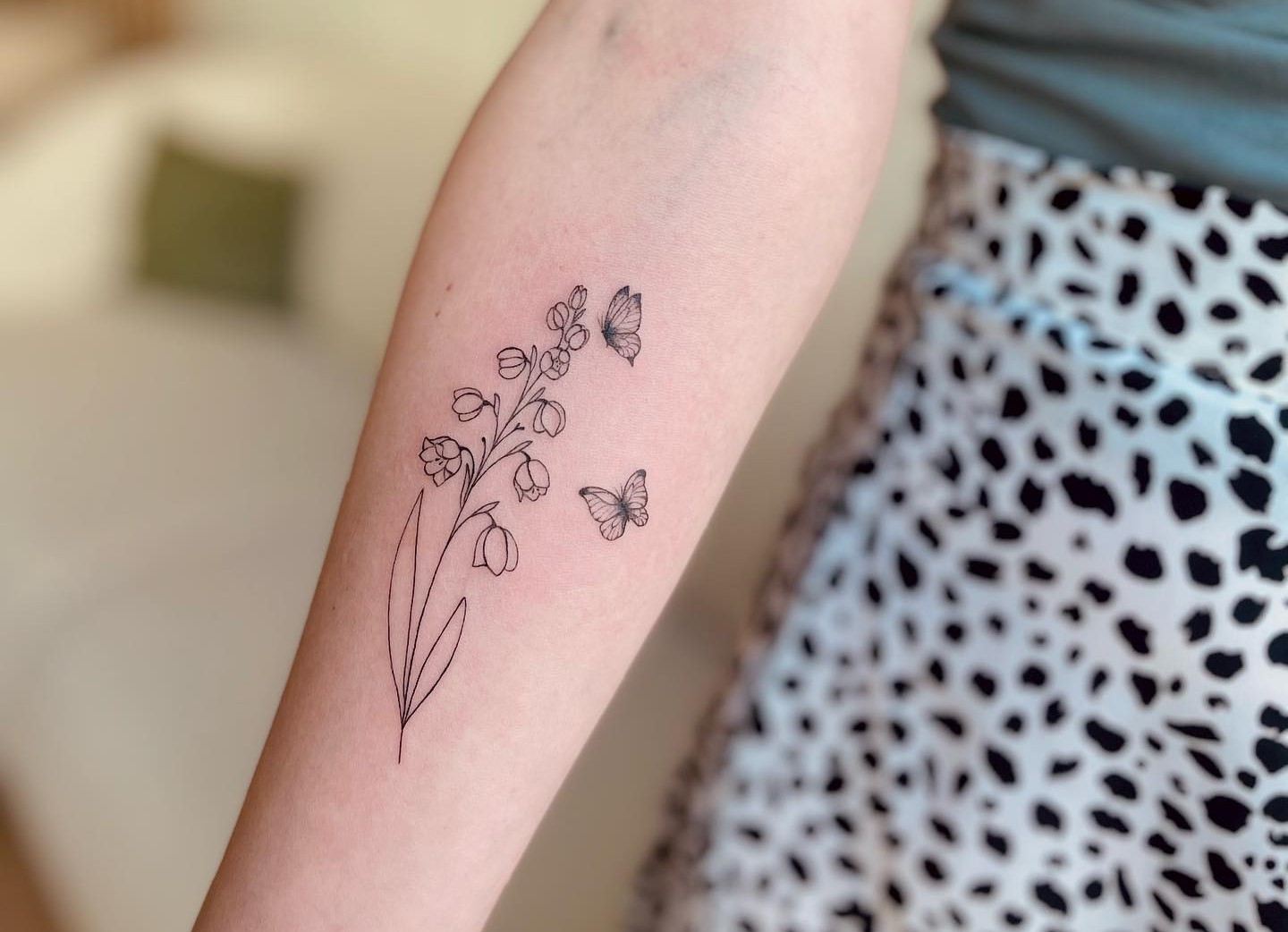 Lily of the Valley tattoo on womans arm Stock Photo  Alamy