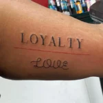 Bold Loyalty Over Love Forearm Render in Capital Letters loyalty over love tattoo e1710390667298 Outsons